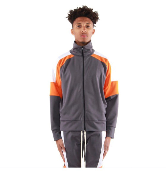 Model wearing a grey EPTM zip-front track jacket with orange and white color-block sleeves